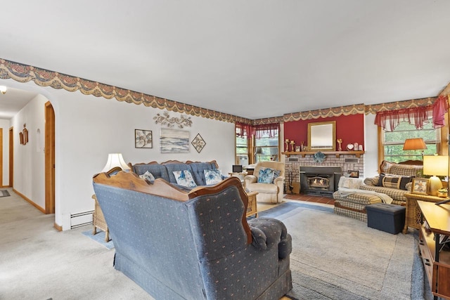 W156N8813 Pilgrim Rd, Menomonee Falls, WI 53051 - living room featuring a baseboard heating unit, carpet floors, arched walkways, a brick fireplace, and baseboards