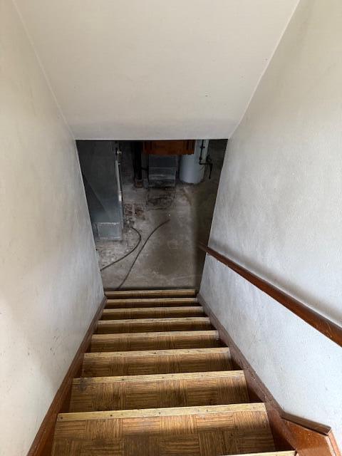 424 S 66th St, Milwaukee, WI 53214 - stairs featuring water heater and concrete flooring
