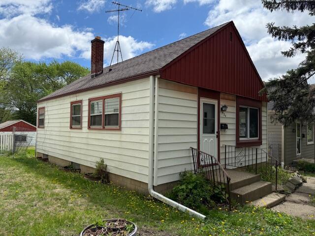 424 S 66th St, Milwaukee, WI 53214 - bungalow-style house with a chimney, roof with shingles, and board and batten siding