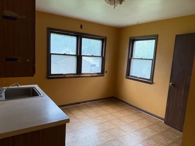 424 S 66th St, Milwaukee, WI 53214 - laundry room featuring baseboards and a sink