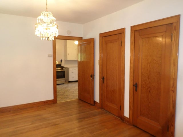 1909 91st St, Pleasant Prairie, WI 53158 - hall with light wood-style flooring, a chandelier, and baseboards