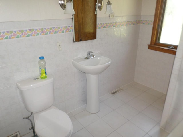 1909 91st St, Pleasant Prairie, WI 53158 - bathroom with tile walls, toilet, tile patterned floors, and a sink