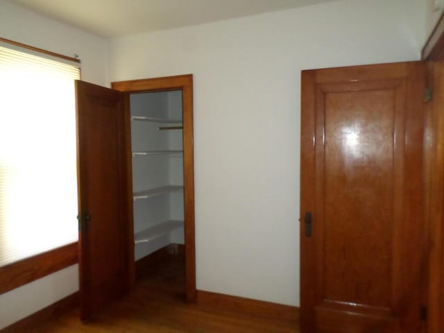 1909 91st St, Pleasant Prairie, WI 53158 - unfurnished bedroom featuring wood finished floors and a closet