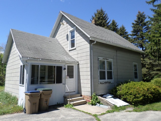 1909 91st St, Pleasant Prairie, WI 53158 - bungalow-style house featuring entry steps, a chimney, and roof with shingles
