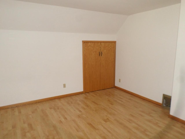 1909 91st St, Pleasant Prairie, WI 53158 - spare room featuring light wood-type flooring, baseboards, and vaulted ceiling