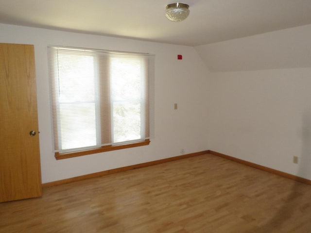 1909 91st St, Pleasant Prairie, WI 53158 - additional living space featuring light wood finished floors, lofted ceiling, and baseboards