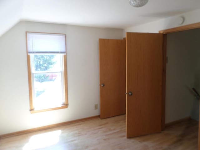 1909 91st St, Pleasant Prairie, WI 53158 - unfurnished bedroom with lofted ceiling and light wood finished floors