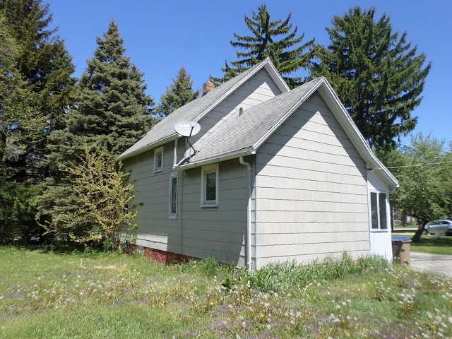 1909 91st St, Pleasant Prairie, WI 53158 - view of side of home with roof with shingles and a chimney