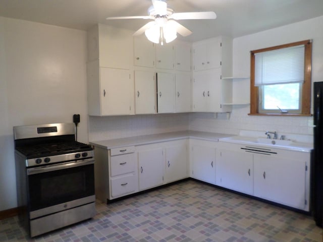 1909 91st St, Pleasant Prairie, WI 53158 - kitchen featuring stainless steel range with gas cooktop, open shelves, light countertops, and white cabinetry