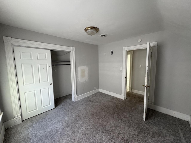 41 E 9th St, Fond Du Lac, WI 54935 - unfurnished bedroom featuring dark carpet, a closet, and baseboards
