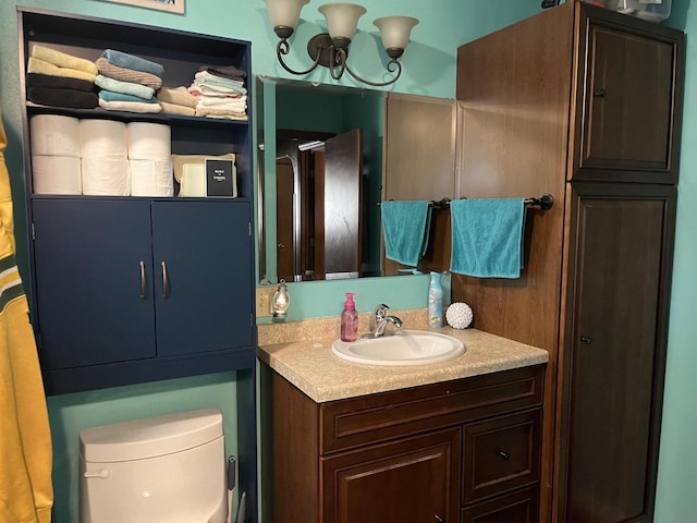 429 Pine St, Tomah, WI 54660 - bathroom with vanity, toilet, and a chandelier