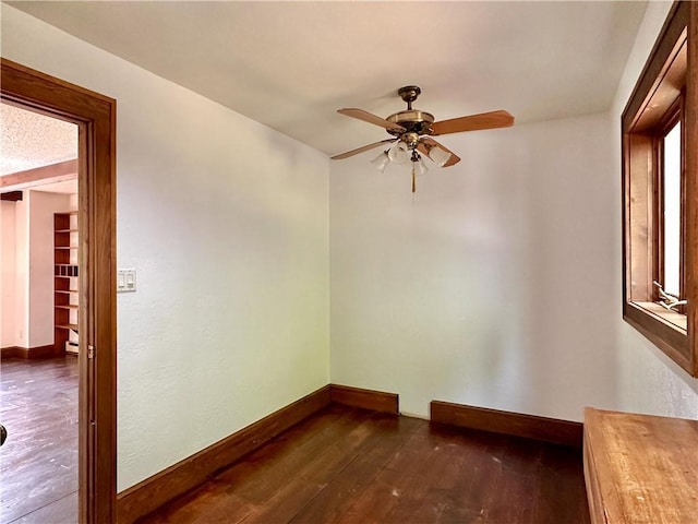 16680W Raining Tree Rd, Stone Lake, WI 54876 - unfurnished room with a ceiling fan, dark wood-type flooring, and baseboards