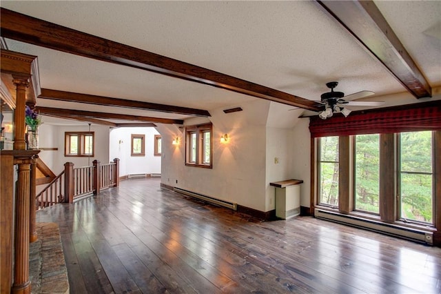 16680W Raining Tree Rd, Stone Lake, WI 54876 - unfurnished living room featuring a baseboard heating unit, a ceiling fan, beamed ceiling, baseboards, and dark wood-type flooring