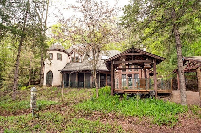 16680W Raining Tree Rd, Stone Lake, WI 54876 - rear view of property with a sunroom, a deck, and stucco siding