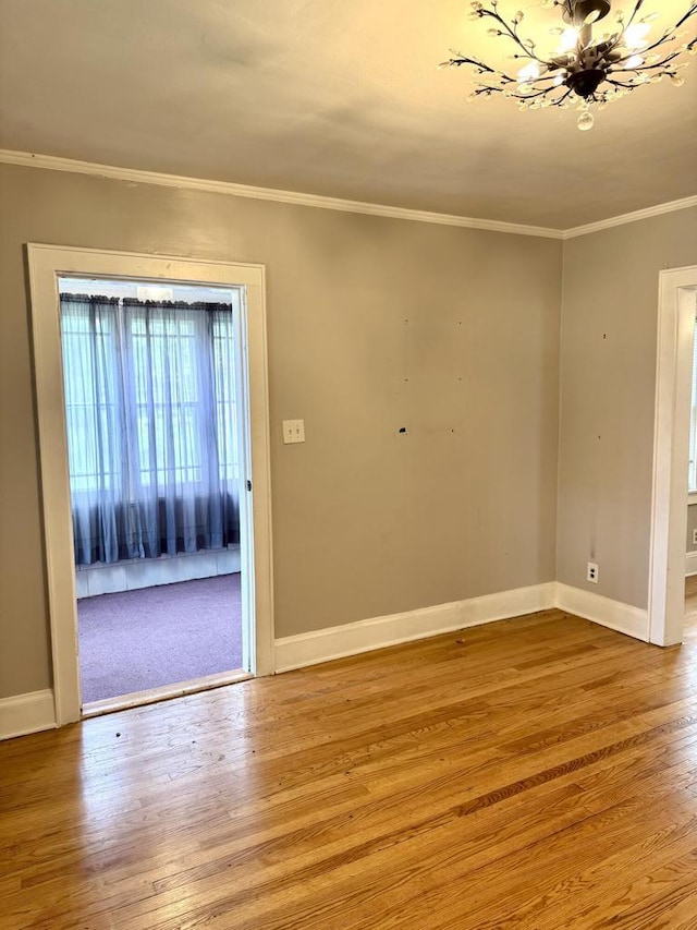4717 N 19th St, Milwaukee, WI 53209 - spare room with a chandelier, wood finished floors, baseboards, and crown molding