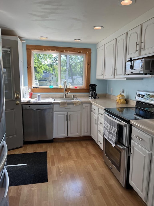 4512 Larson St, Mcfarland, WI 53558 - kitchen featuring stainless steel appliances, a sink, white cabinetry, and recessed lighting