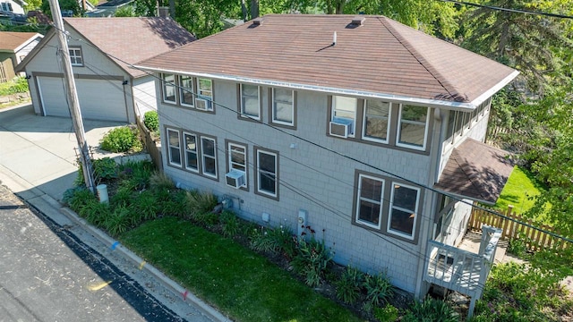 4512 Larson St, Mcfarland, WI 53558 - view of front facade with driveway, a shingled roof, a chimney, and cooling unit