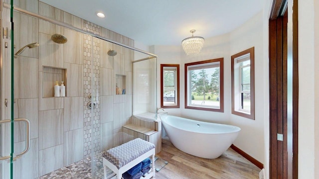 W10559 Hickory Point Rd, Beaver Dam, WI 53916 - bathroom with tiled shower, a freestanding bath, wood finished floors, baseboards, and recessed lighting