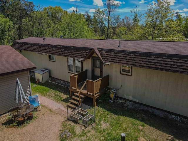13511 59th St S, Wisconsin Rapids, WI 54494 - rear view of property with roof with shingles, a wooden deck, and an outdoor fire pit