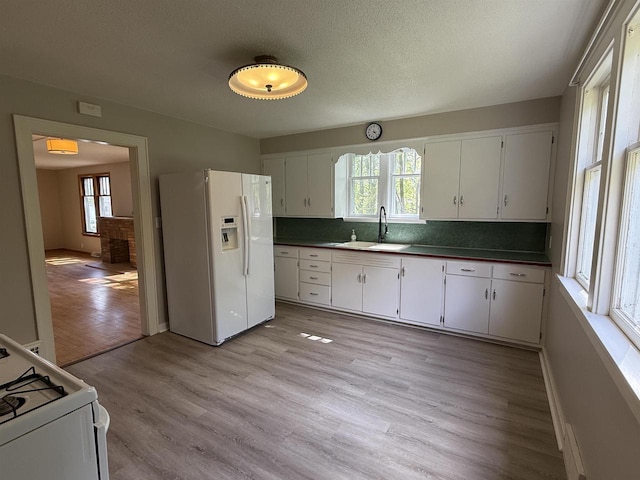 3400 Vine St, Stevens Point, WI 54481 - kitchen featuring white appliances, a sink, dark countertops, and white cabinets