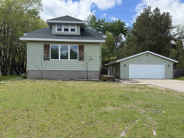 3400 Vine St, Stevens Point, WI 54481 - view of front facade with a garage, a front yard, roof with shingles, and an outbuilding