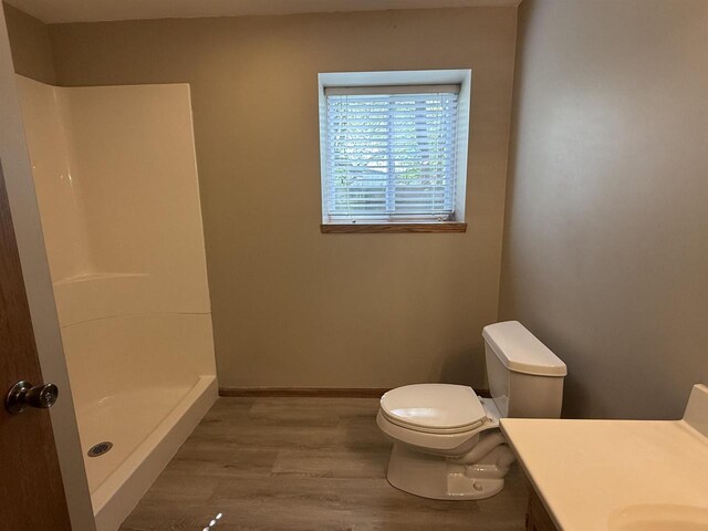 3400 Vine St, Stevens Point, WI 54481 - bathroom featuring toilet, a stall shower, wood finished floors, vanity, and baseboards