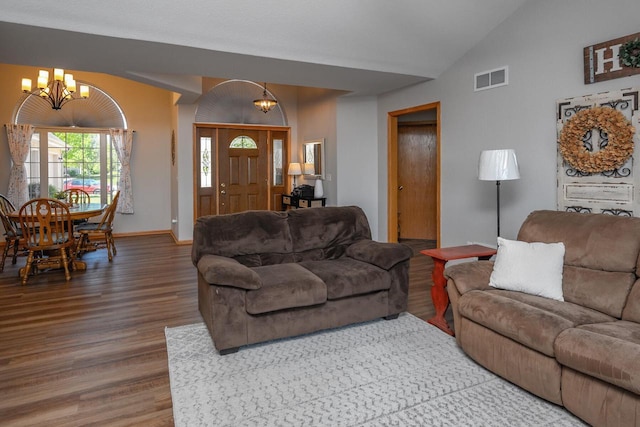 217 Steeple Ct, Johnson Creek, WI 53038 - living room featuring a chandelier, wood finished floors, vaulted ceiling, and baseboards