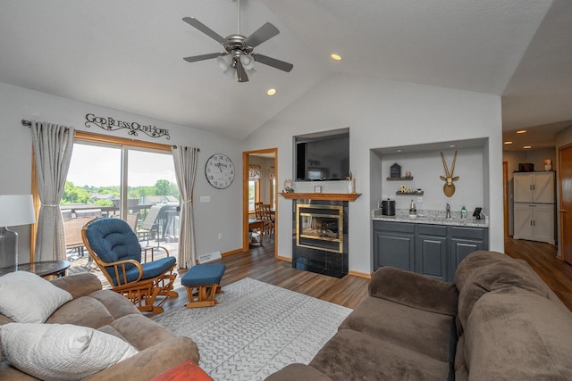 217 Steeple Ct, Johnson Creek, WI 53038 - living room with a ceiling fan, wood finished floors, wet bar, baseboards, and a fireplace