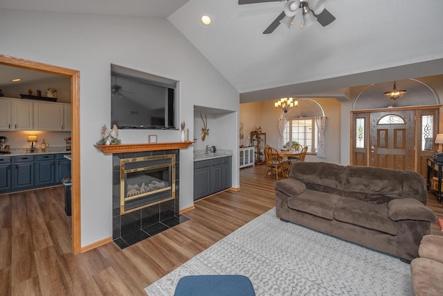 217 Steeple Ct, Johnson Creek, WI 53038 - living area with a chandelier, a ceiling fan, a fireplace, wood finished floors, and high vaulted ceiling