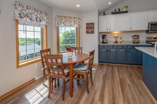 217 Steeple Ct, Johnson Creek, WI 53038 - dining room with light wood-type flooring, lofted ceiling, recessed lighting, and baseboards