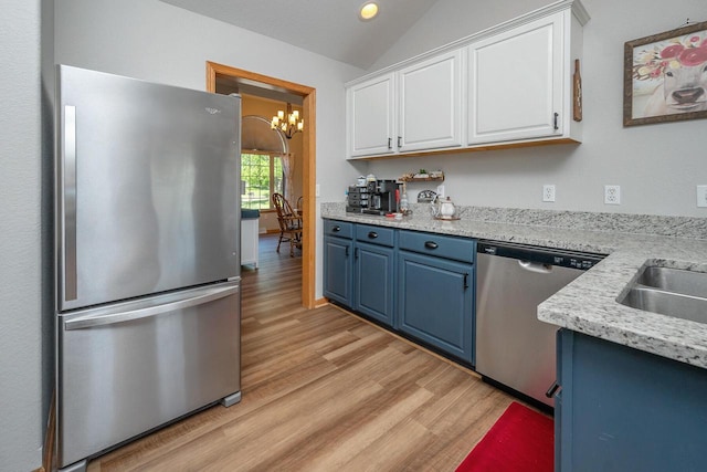 217 Steeple Ct, Johnson Creek, WI 53038 - kitchen featuring stainless steel appliances, blue cabinets, light wood-style flooring, a chandelier, and lofted ceiling