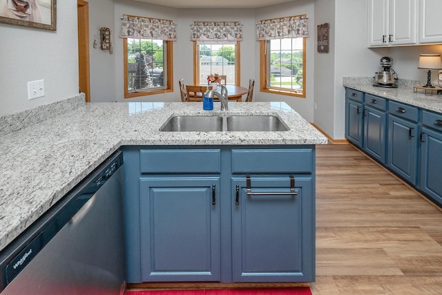 217 Steeple Ct, Johnson Creek, WI 53038 - kitchen with blue cabinets, dishwasher, a sink, light wood finished floors, and white cabinetry