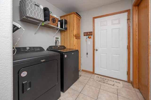 217 Steeple Ct, Johnson Creek, WI 53038 - laundry room featuring washing machine and clothes dryer, cabinet space, and light tile patterned floors