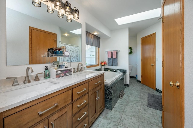 217 Steeple Ct, Johnson Creek, WI 53038 - bathroom with a skylight, double vanity, toilet, a garden tub, and tile patterned floors