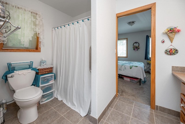 217 Steeple Ct, Johnson Creek, WI 53038 - bathroom with vanity, toilet, curtained shower, tile patterned floors, and connected bathroom