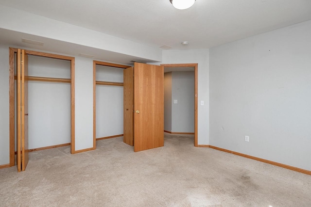 217 Steeple Ct, Johnson Creek, WI 53038 - unfurnished bedroom featuring multiple closets, light colored carpet, and baseboards