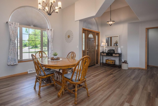 217 Steeple Ct, Johnson Creek, WI 53038 - dining room with a chandelier, wood finished floors, baseboards, and high vaulted ceiling