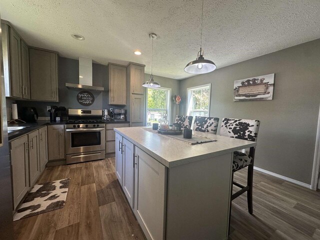 916 S Madison St Unit 9, Waupun, WI 53963 - kitchen with stainless steel gas range oven, wall chimney exhaust hood, dark wood-style flooring, a textured ceiling, and a center island