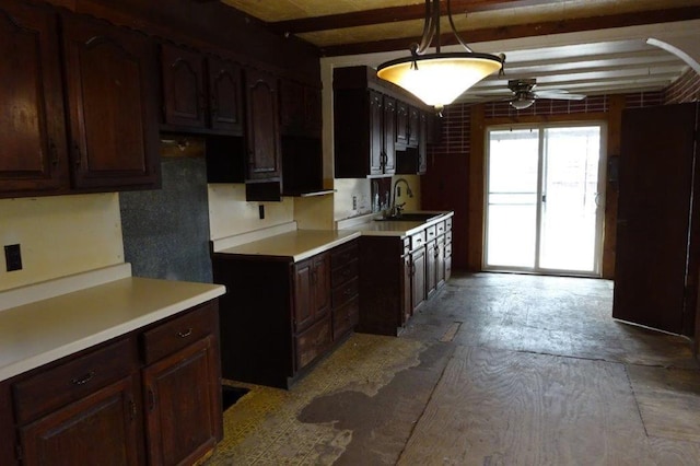 1305 La Crescent St, La Crosse, WI 54603 - kitchen featuring a ceiling fan, a sink, beamed ceiling, dark brown cabinets, and light countertops