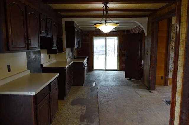 1305 La Crescent St, La Crosse, WI 54603 - kitchen featuring arched walkways, a sink, dark brown cabinets, beam ceiling, and hanging light fixtures