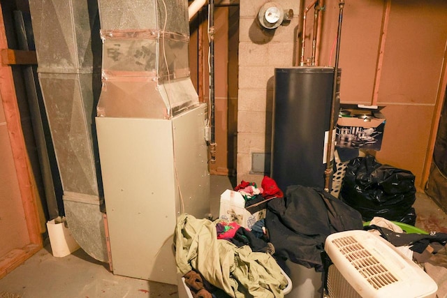 1133 Smith Ave, Antigo, WI 54409 - unfinished below grade area with gas water heater, heating unit, and concrete block wall