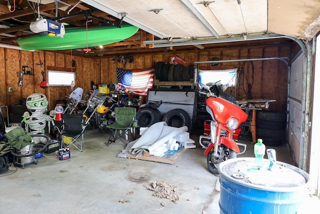 1133 Smith Ave, Antigo, WI 54409 - garage with a garage door opener and wooden walls