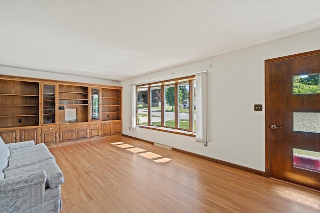 15 Wilson Ave, Fort Atkinson, WI 53538 - unfurnished living room featuring light wood finished floors, baseboards, and plenty of natural light