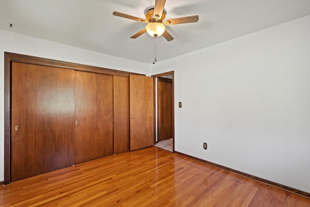 15 Wilson Ave, Fort Atkinson, WI 53538 - unfurnished bedroom featuring a closet, light wood-style floors, baseboards, and a ceiling fan