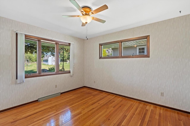 15 Wilson Ave, Fort Atkinson, WI 53538 - unfurnished room with wood finished floors, wallpapered walls, ceiling fan, and baseboards