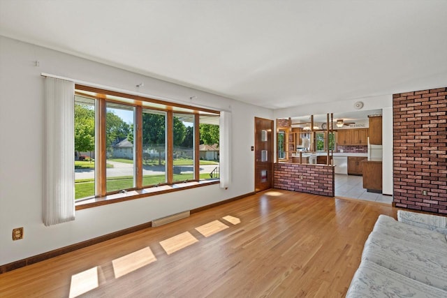15 Wilson Ave, Fort Atkinson, WI 53538 - unfurnished living room with light wood-style floors and baseboards