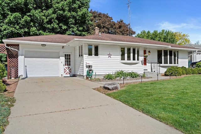 15 Wilson Ave, Fort Atkinson, WI 53538 - single story home featuring an attached garage, a front lawn, driveway, and a chimney