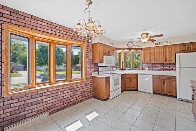15 Wilson Ave, Fort Atkinson, WI 53538 - kitchen featuring white appliances, brick wall, light countertops, brown cabinets, and light tile patterned floors