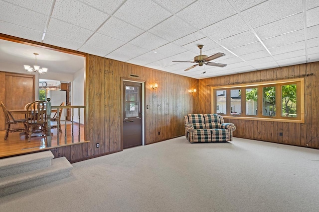 15 Wilson Ave, Fort Atkinson, WI 53538 - living area with wood walls, carpet floors, a chandelier, and a ceiling fan