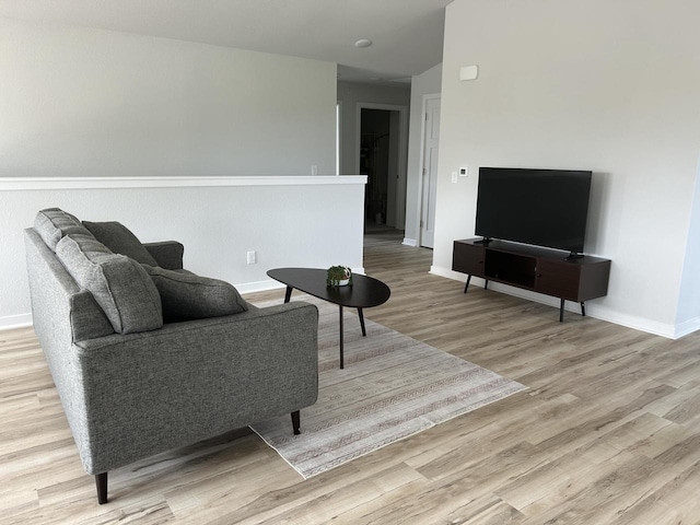 W141N9978 Seven Pines Way Unit 204, Germantown, WI 53022 - living room featuring baseboards, wood finished floors, and vaulted ceiling